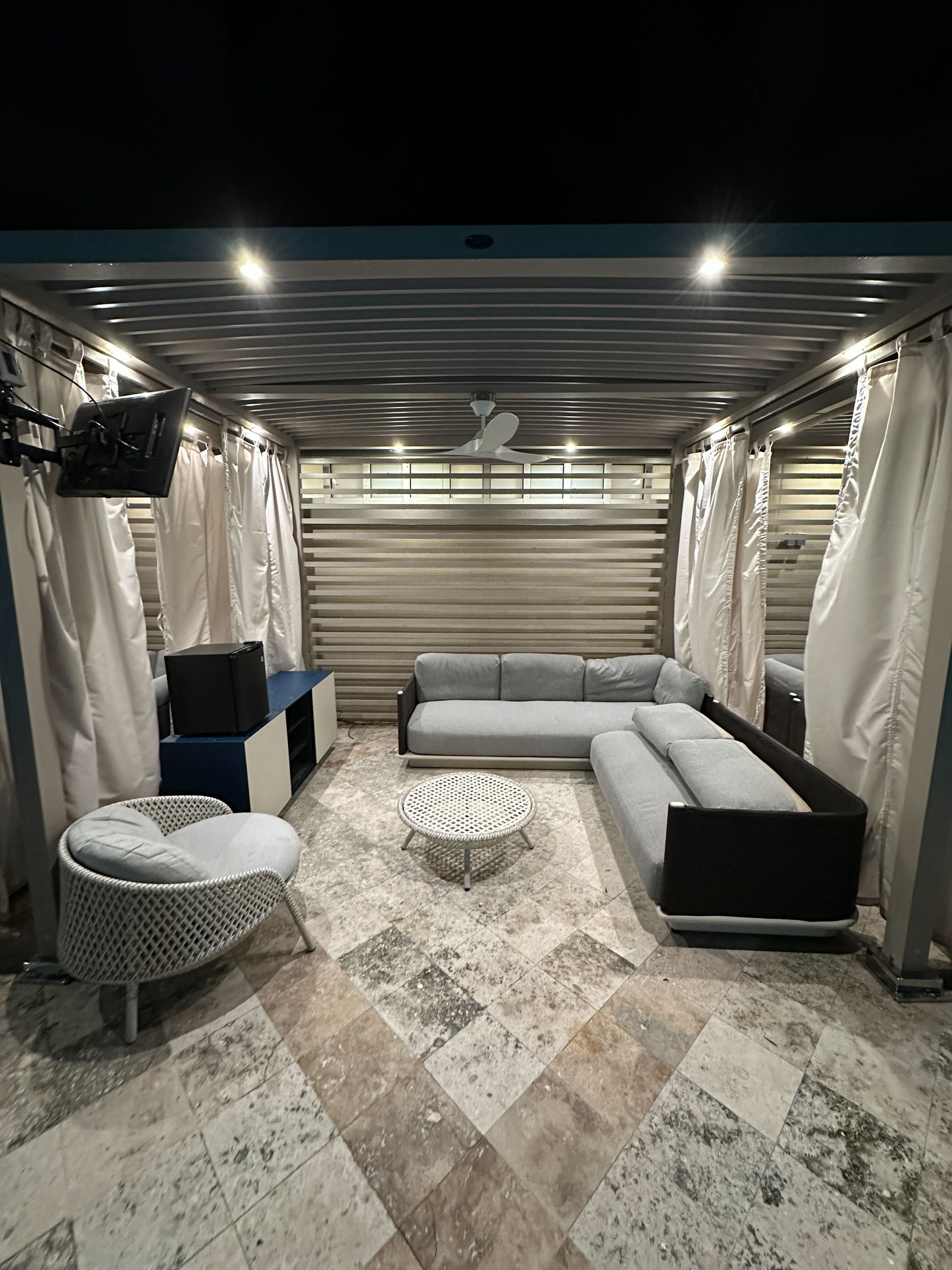 VIP cabana interior — L-shaped lounge seating, coffee table