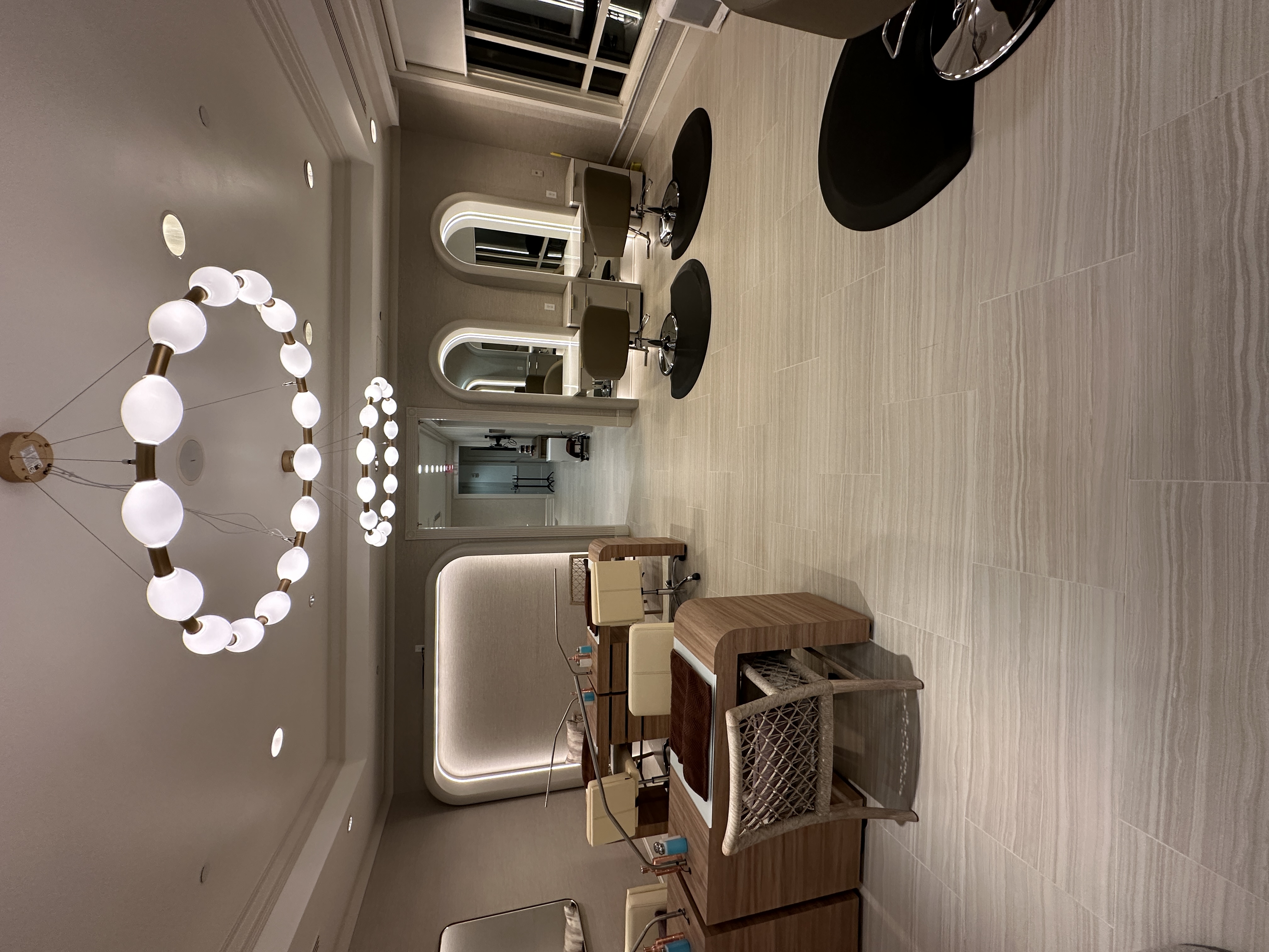 Salon with globe chandelier and arched mirrors