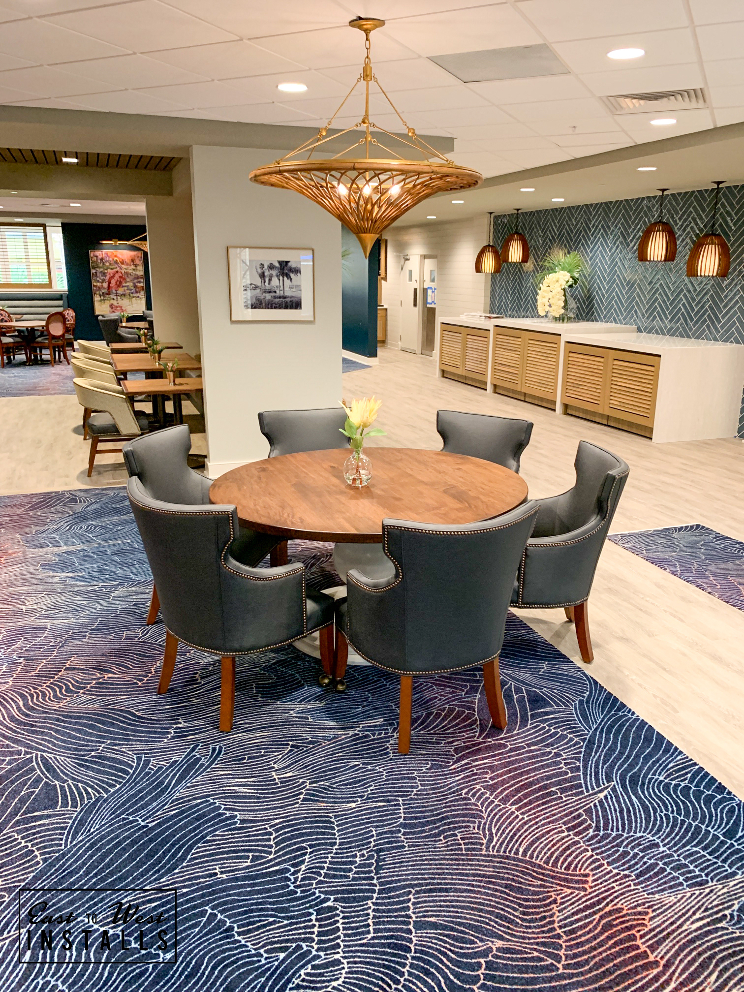 Village on the Isle — dining chandelier with social bar in background